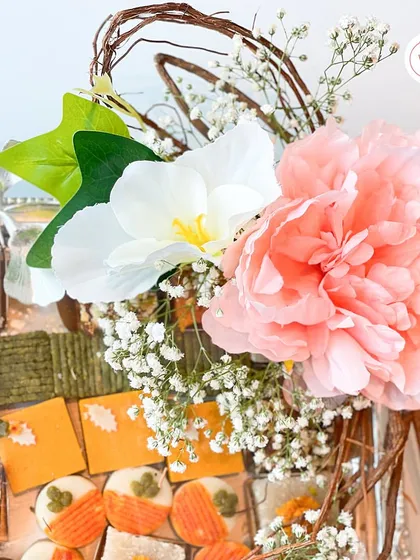 A close-up of the mithai hamper, showing the variety of sweets and the beautiful floral arrangement.