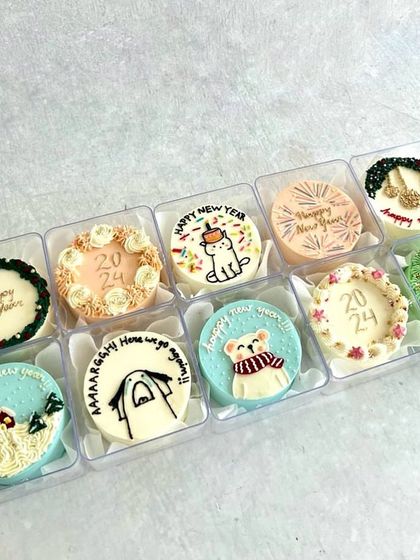 A festive collection of mini bento cakes for the New Year, with clocks, fireworks, and wintery designs to ring in 2024.