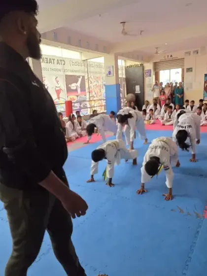 I observe the class as they perform their warm-up exercises.