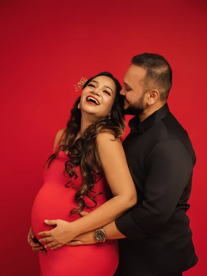 Radiant laughter. This couple's portrait against a bold red background is full of joy and energy. Capturing genuine laughter is one of my favorite parts of any session.