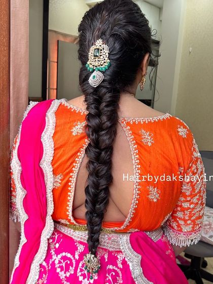 A slightly different angle showing the length and texture of the fishtail braid with a beautiful hair accessory.