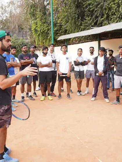 Here I am, addressing a group of players and coaches on the court. My approach is hands on and direct. I believe in creating an environment where players are challenged to think and grow.