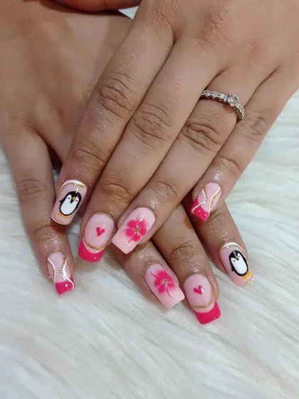 I love creating cute and quirky designs. This set features hand-painted penguins, delicate pink flowers, tiny hearts, and a modern French tip, all on a set of square acrylic extensions.