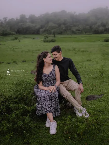 A quiet moment together, sitting on a rock in a misty green field. This is a perfect example of a peaceful, romantic portrait.
