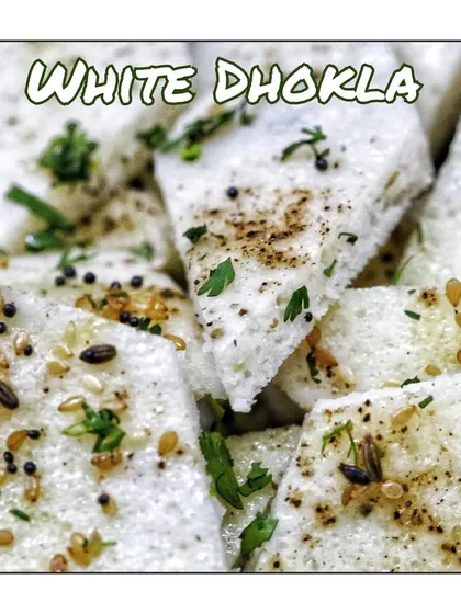 My White Dhokla, also known as Khatta Dhokla. Made from a fermented batter of rice and lentils, this tangy and soft dhokla is a healthy, steamed snack.