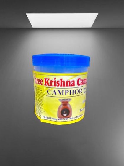 This is our camphor tub with a blue lid, professionally lit to showcase the product label and branding. Camphor is a traditional element used in Indian households for its purifying properties.
