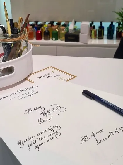 My workspace during the in-store activation. You can see my collection of pens and inks ready to go, with examples of romantic quotes and messages I prepared for the event.