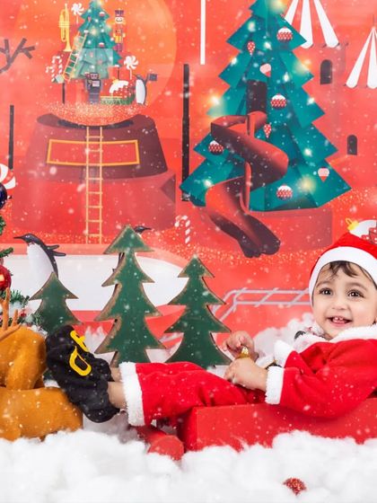 A fun, candid shot of a baby Santa enjoying his sleigh ride in our festive Christmas setup.