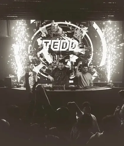 A classic black and white shot with pyro erupting, creating a timeless and epic party moment.