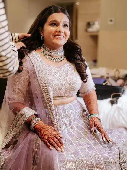 A getting-ready shot of the bride for her reception, looking happy and relaxed.