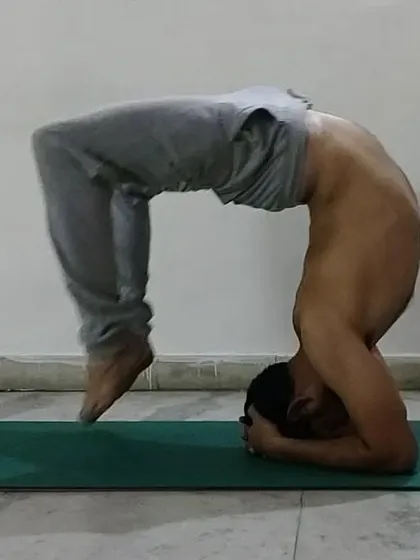 A variation of the headstand where the back is deeply arched. This pose combines the challenges of an inversion with the benefits of a deep backbend.