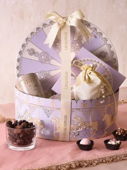 The Amethyst Carnival hamper is designed to bring sweetness and light to your celebration. It includes honey choco almonds, sugar-free mithai, and mini butter cookies in a gorgeous lavender box.