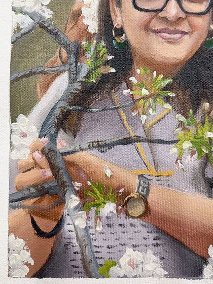 A detail shot of the hands and the delicate blossoms.