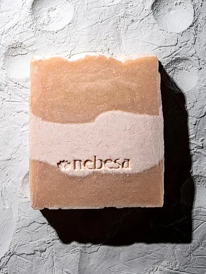 A close-up of my Ubtan Sandalwood soap bar. This two-toned soap is designed to provide a cooling effect in the summer and help with heat rashes or back acne.