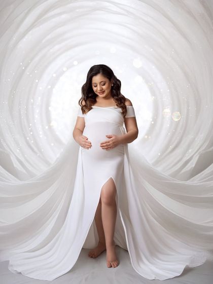 A magical, creative edit, placing the mom-to-be inside a swirling vortex of white fabric with sparkling lights.
