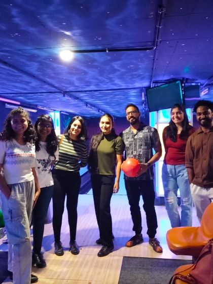 A group of friends at our bowling alley, one holding a bowling ball.