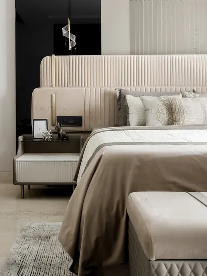 A detail shot of the son's bedroom, showcasing the elevated restraint in the design. A fluted velvet headboard meets brushed metal accents, while the ribbed nightstand adds quiet sophistication.