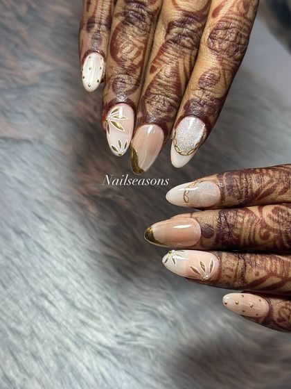 The contrast between the detailed mehndi and the clean, elegant nail art is just stunning. This is a perfect example of modern bridal nails.