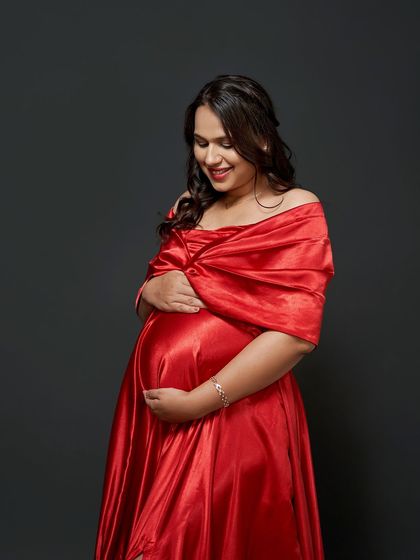 A tender moment captured in our studio. The rich red satin of the Valentina gown provides a beautiful pop of color against the dark backdrop.