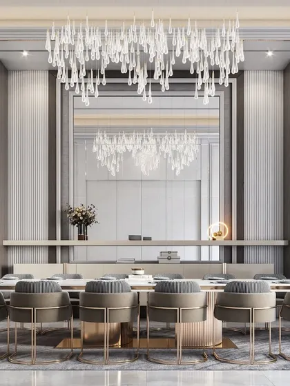 An opulent dining room designed for memorable gatherings, featuring a magnificent cascading chandelier over a 12-seater table, complemented by elegant wall panels and integrated display units.