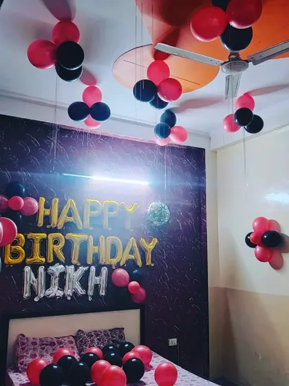This angle captures the full effect of the personalized birthday room setup, with the custom name 'NIKH' clearly visible.