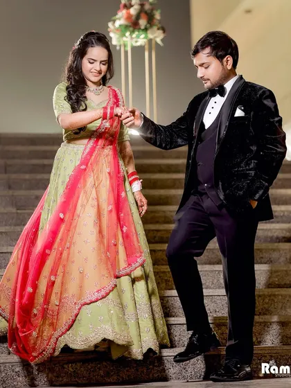 A classic engagement ceremony shot of the groom helping his bride down the stairs. It's a chivalrous and romantic moment that looks beautiful in photos.