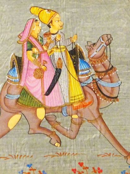 A beautiful example of Indian miniature painting, known for its intricate details and delicate brushwork, depicting a royal couple on a camel.