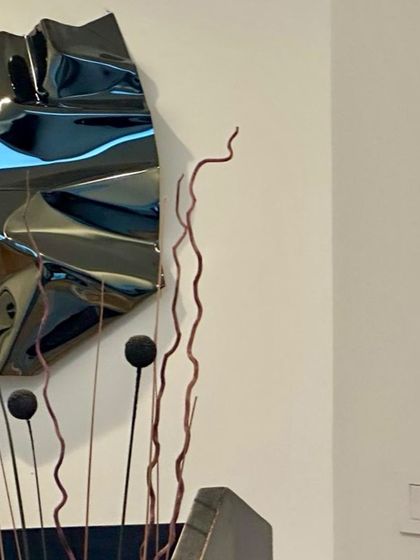 A close-up showing the interaction between the black sculpture and other decorative elements.