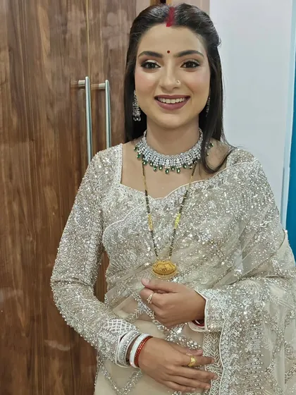Blended to perfection. This newly married look features a simple yet elegant half-up hairstyle that complements her sparkling saree and glowing makeup.