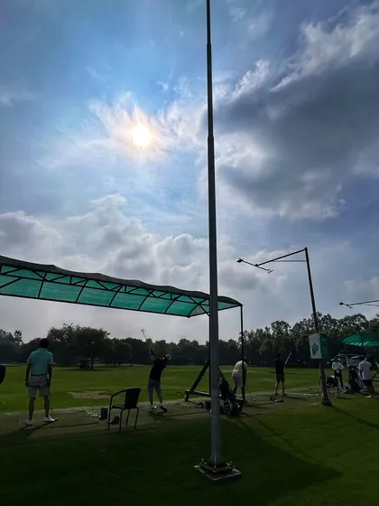 The sun beats down as golfers practice their swings from the shade of our covered bays.
