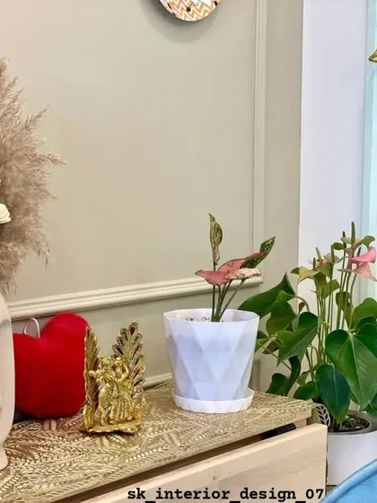 A close-up of styling details. We believe in adding personal touches with decor items like unique vases, small plants, and metallic accents to make a house feel like a home.
