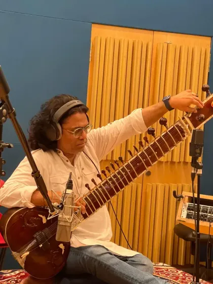A moment of tuning the sitar during a recording session. Precision is key to achieving the right sound.