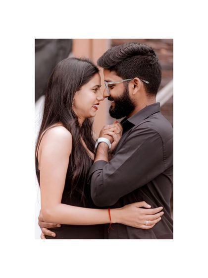 A simple, beautiful, and intimate portrait. The couple's foreheads are touching as they share a private smile, capturing a moment of pure connection.