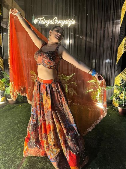 A fun, twirling shot in the vibrant Aisha Rao lehenga. It's a perfect outfit for a sangeet night, full of color and life.