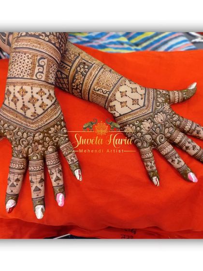 A lovely back-hand design for the groom's mother, with intricate check patterns and floral motifs.