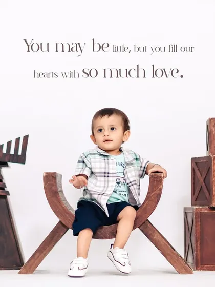 A charming studio portrait for a first birthday, featuring our rustic props like the wooden windmill and "ONE" blocks. We create a complete, stylized scene for your child.