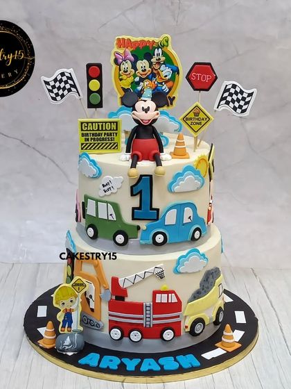A unique dual-theme cake for a first birthday, combining a car theme with Minnie Mouse. This 7kg two-tier choco-chip cake is perfect for a grand celebration with diverse interests.
