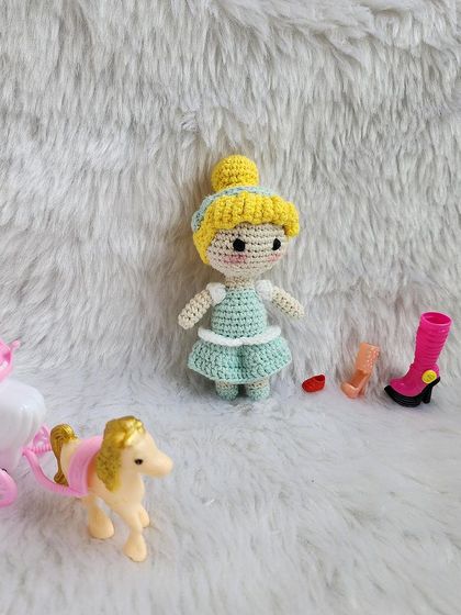 The classic Disney princess, Cinderella. She is dressed in her beautiful light blue ball gown with her hair in a neat bun, ready for the royal ball.