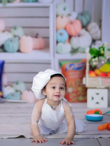 Our little chef is getting messy with flour. This is a fun and interactive "chef theme" shoot, perfect for a first birthday.