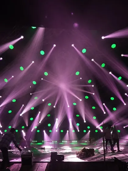 Dancers rehearsing on the 'Po Po' set under one of the lighting looks, a combination of purple beams and green washes.