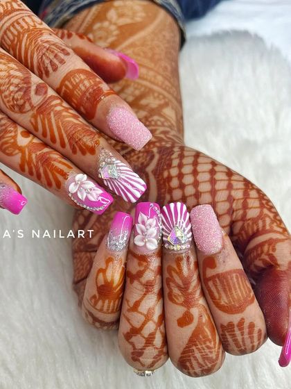 A different view of this bold pink bridal set, showcasing the intricate details and how they complement the bride's henna.