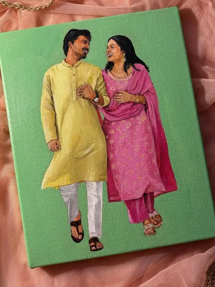 A still shot of the happy couple in their traditional yellow and pink outfits against a soft green background. This painting captures a candid, joyful moment.