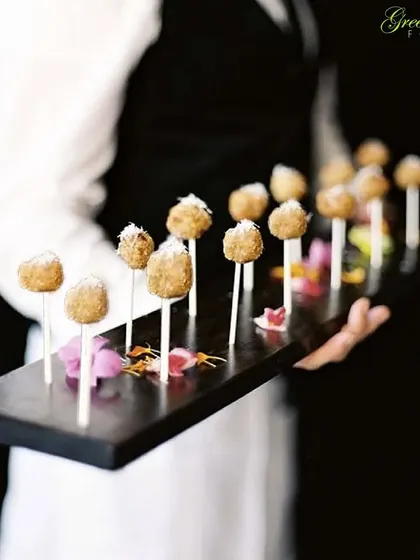 These bite-sized lollipops are a creative and delicious appetizer. They are easy for guests to pick up and enjoy while mingling, showcasing our focus on practical and elegant finger foods.