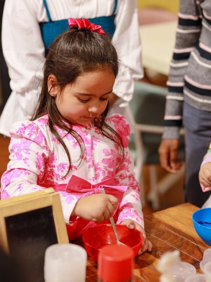 A child gets her hands messy with a fun slime-making activity. We can arrange for all sorts of popular crafts and experiments.