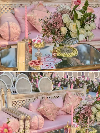 A look at the lounge seating, featuring traditional Indian daybeds with plush pink cushions. The mirrored table reflects the sky and the custom-designed stationery.