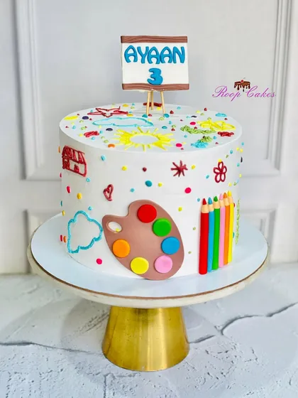 Where cake meets art. This hand-painted edible fondant cake is perfect for a little artist's 3rd birthday, decorated with a palette, colored pencils, and cute drawings.