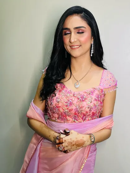 A close-up of the client with her eyes closed, showing the delicate blend of pink and shimmer eyeshadow for her Roka ceremony. The look is soft, romantic, and picture-perfect.