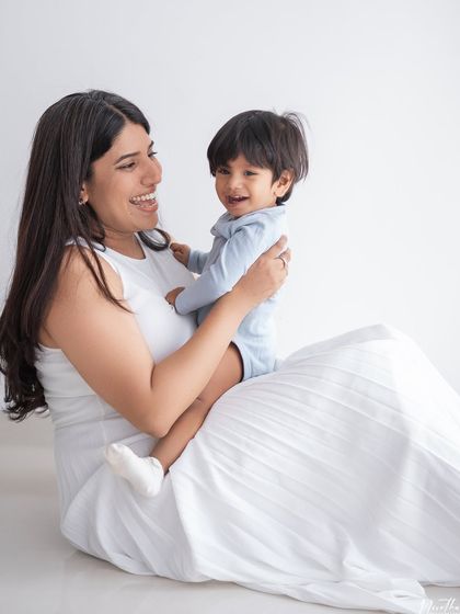 A mother and son sharing a laugh during their studio session.