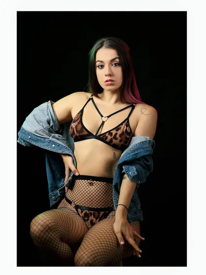 A more revealing shot from the same series, showcasing the model's edgy style with an animal print lingerie set.