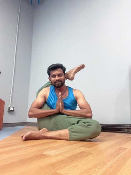 Eka Pada Sirsasana, or foot-behind-head pose, is an advanced posture that requires immense hip flexibility. It's a journey of patience and consistent practice.